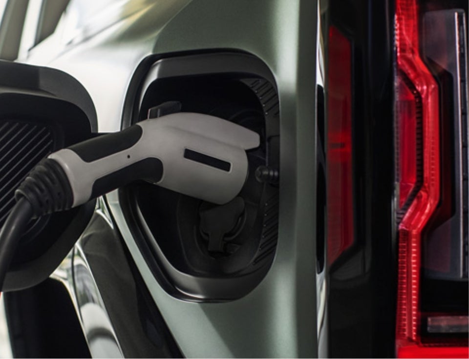 Close up of charging port with charger plugged in on a GMC Hummer EV SUV - Parker GMC in ASHBURN GA