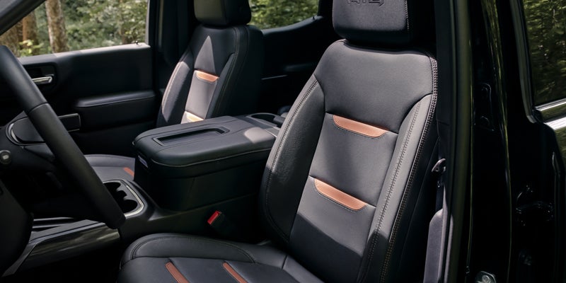 front seats of a GMC Sierra 1500, with a glimpse of the steering wheel in the foreground.