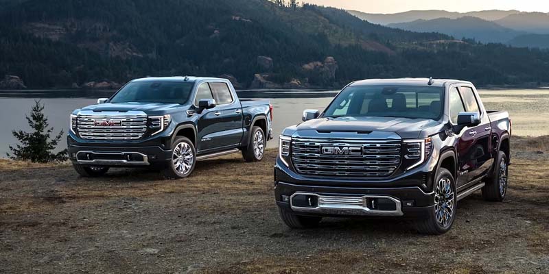 GMC Sierra 1500 with an incredible mountain and lake backdrop.