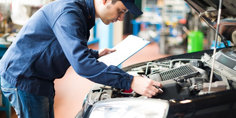 Parker GMC in ASHBURN GA technician working on an engine